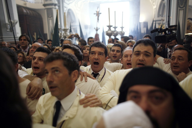 Banderas sings a song to the Virgin as he takes part as a penitent in a Palm Sunday procession during Holy Week in Malaga