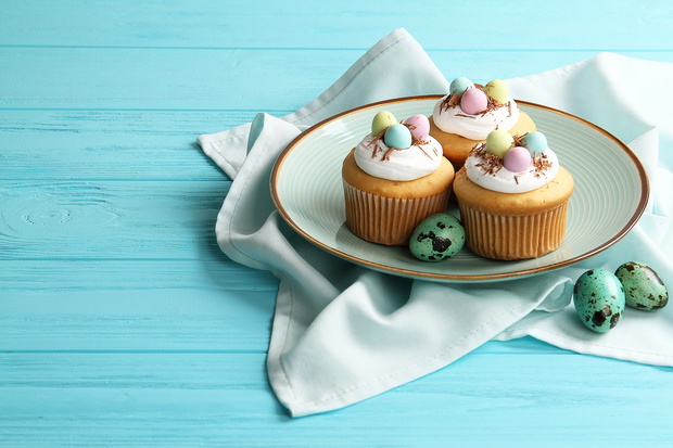 Easter cupcakes on a plate on a table with space for text