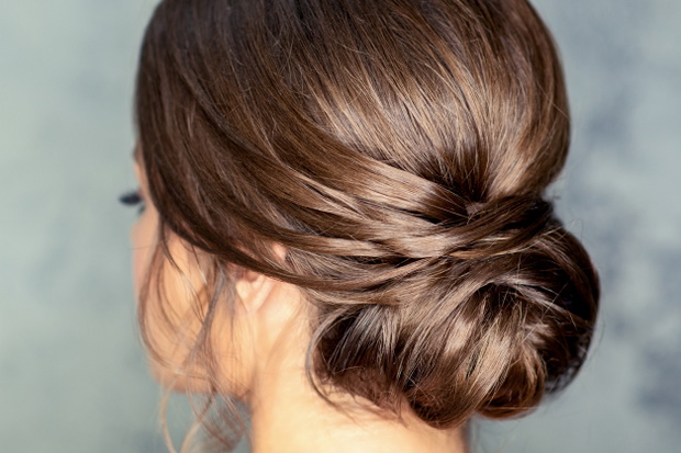 Brunette woman with middle bun hairstyle