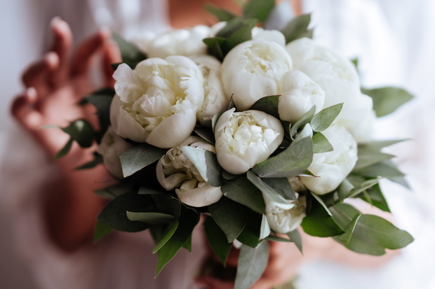 Close-up image of a beautiful and stylish wedding bouquet of white peonies.