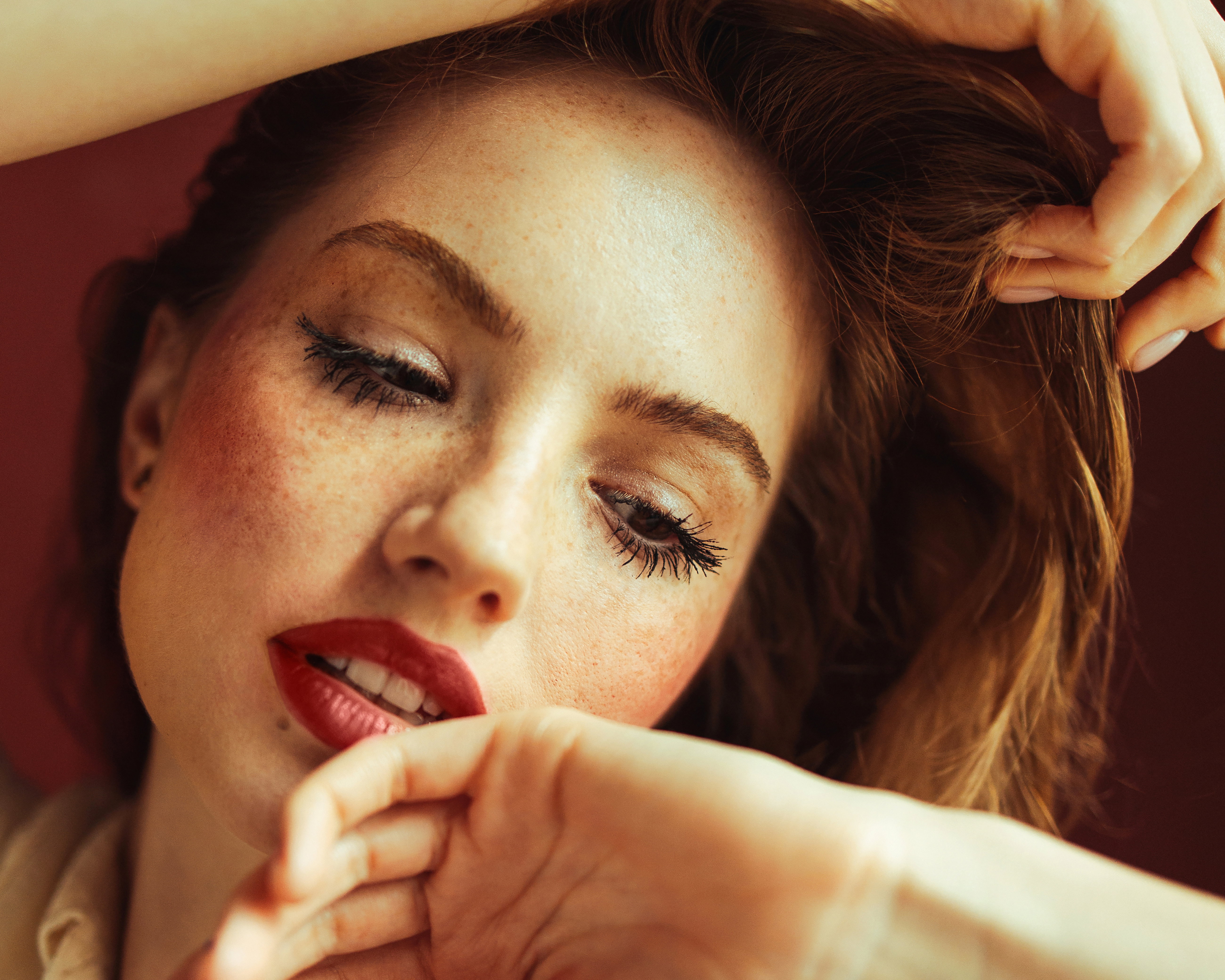 Young woman with hands covering head