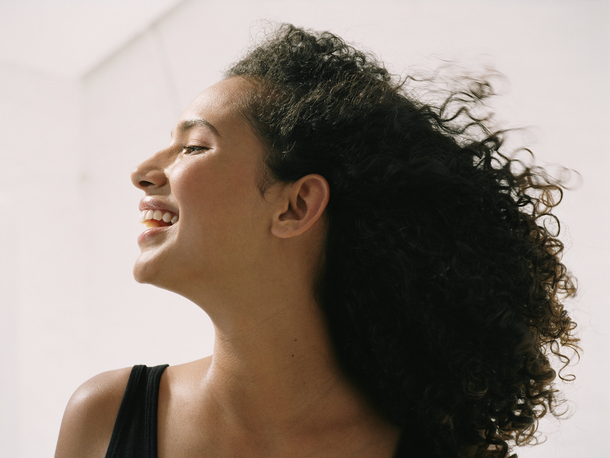 Young woman smiling, close up, side view