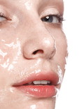 Beautiful young girl with a light natural make-up and perfect wet skin. Beauty face.